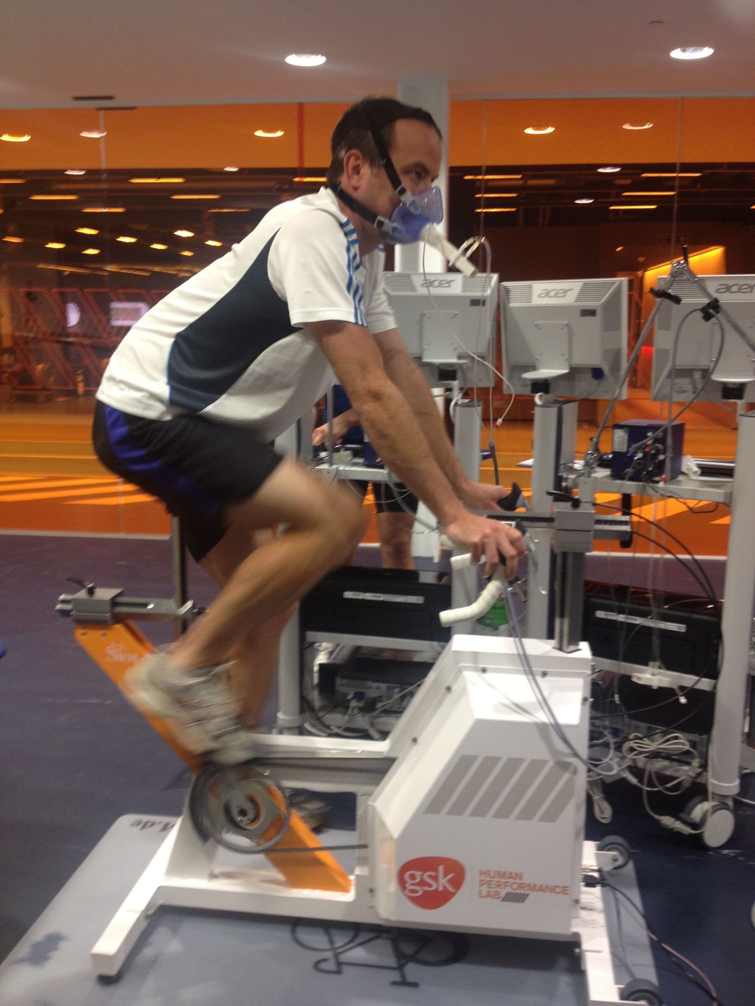 Athlete on a bike with lab equipment around